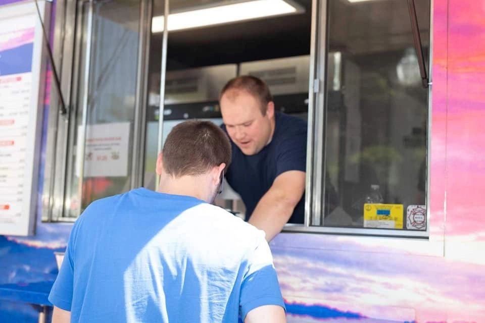 Customer ordering at food truck service window