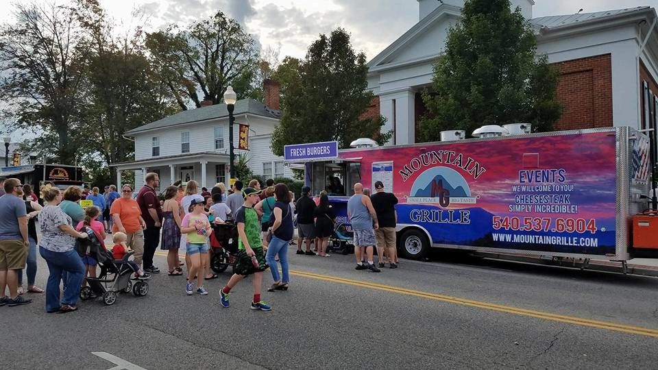 Food truck event on street with historic buildings