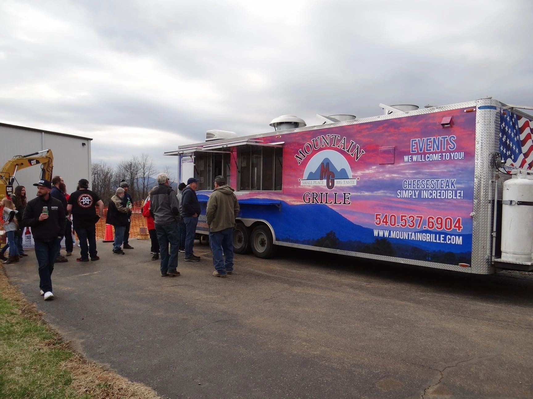 Two Mountain Grille food trucks side by side