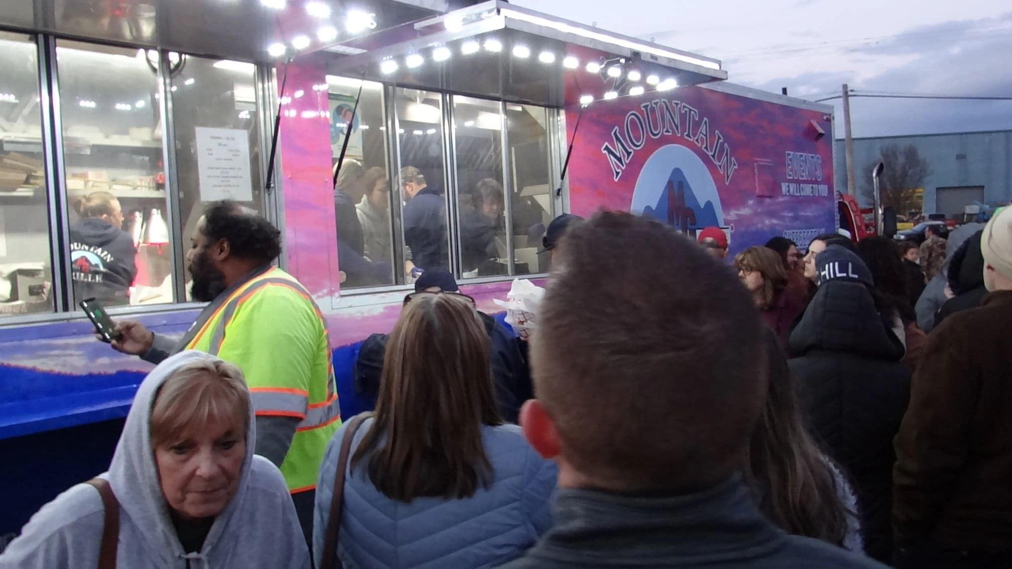 Crowd waiting at food truck in winter